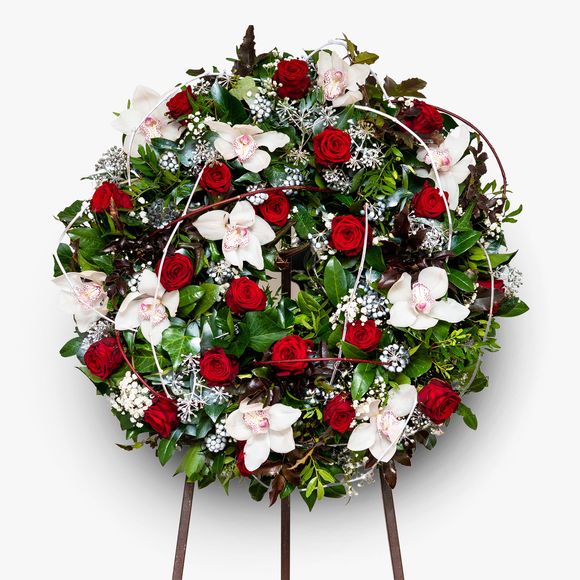 Funeral wreath with red roses and orchids