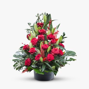 Funeral arrangement with red roses and lilies