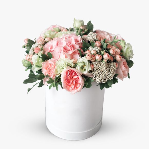 Arrangement with pink roses and hydrangeas in a box