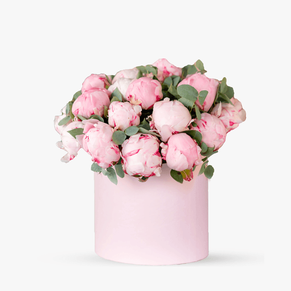 Arrangement in a box with pink peonies