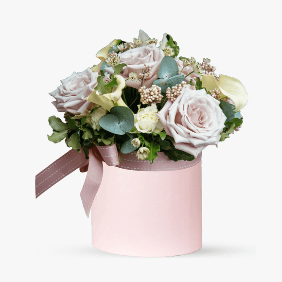 Arrangement in a box with roses and eucalyptus