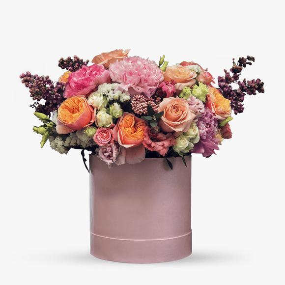 Arrangement in a box with peonies and lilac